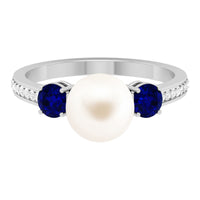 White pearl and sapphire 3-stone engagement ring with diamonds by Rosec Jewels, showcasing elegant gemstones on a platinum band.