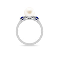 White pearl and sapphire three-stone engagement ring with diamond accents by Rosec Jewels, showcasing elegant jewelry craftsmanship.