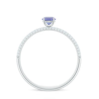 Natural Tanzanite engagement ring with pave diamond side stones, featuring a silver band and intricate detailing from Rosec Jewels.