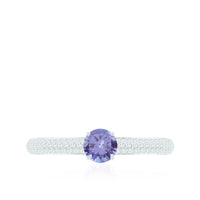 Natural Tanzanite engagement ring with pave diamond side stones, featuring a silver band, from Rosec Jewels.