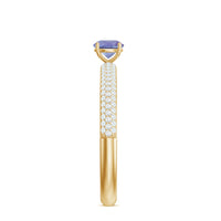 Natural tanzanite engagement ring by Rosec Jewels with pave diamond side stones and intricate band detail.