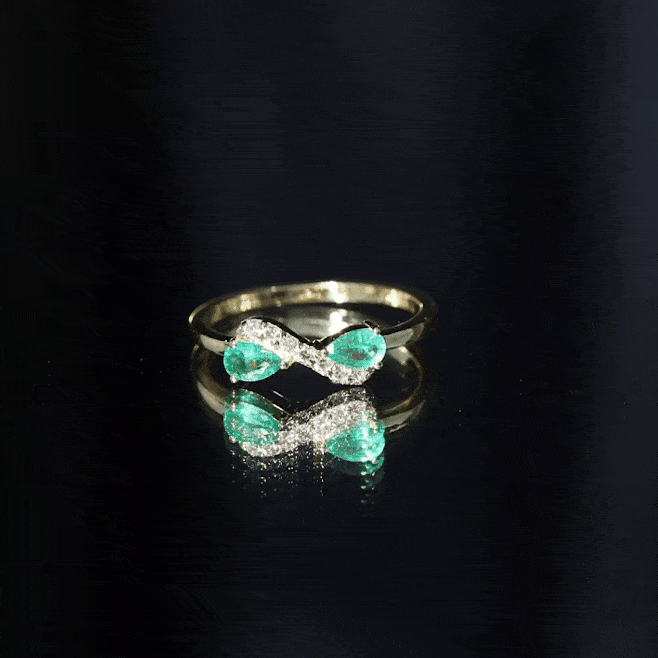 Natural pear emerald and diamond infinity promise ring by Rosec Jewels, showcasing a yellow gold band with sparkling gemstones.