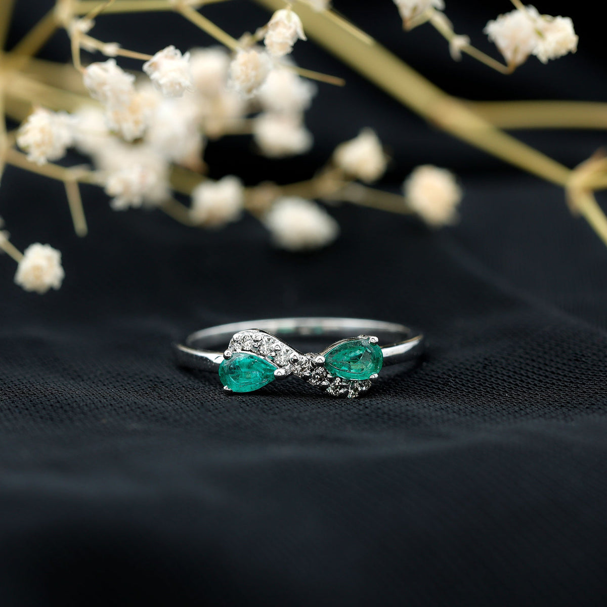 Natural pear emerald and diamond infinity promise ring from Rosec Jewels, featuring elegant gemstone and intricate band design.