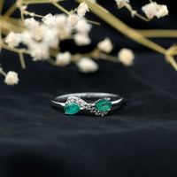 Natural pear emerald and diamond infinity promise ring from Rosec Jewels, featuring elegant gemstone and intricate band design.