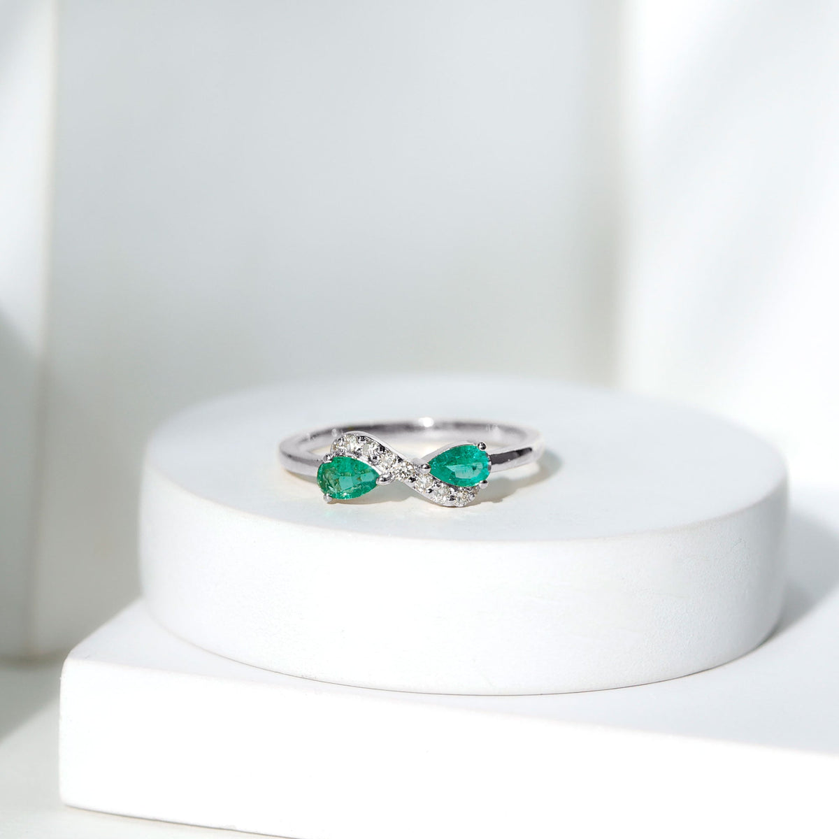 Natural Pear Emerald and Diamond Infinity Promise Ring by Rosec Jewels, featuring a pear-shaped emerald and sparkling diamonds.