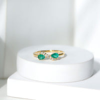 Natural Pear Emerald and Diamond Infinity Promise Ring by Rosec Jewels, showcasing a gold band with pear-shaped emeralds and sparkling diamonds.