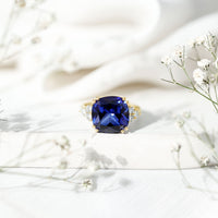 Certified 9 Carat Lab Grown Blue Sapphire Cushion Cut Engagement Ring with Diamond Trio