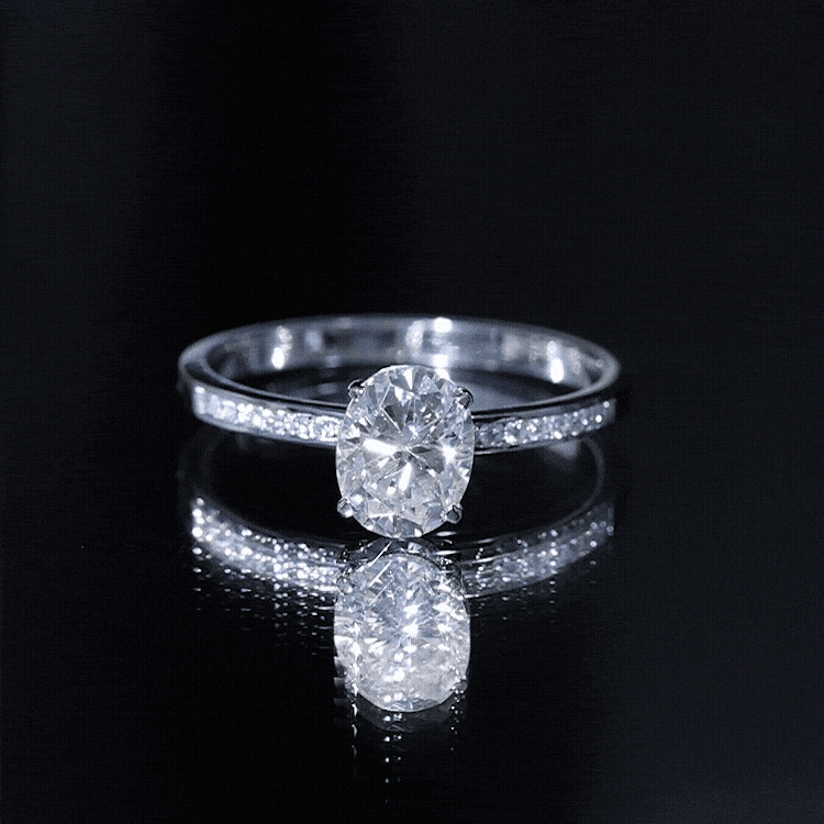 Rosec Jewels 7x9 mm lab-grown diamond oval engagement ring with yellow gold band and intricate setting details.