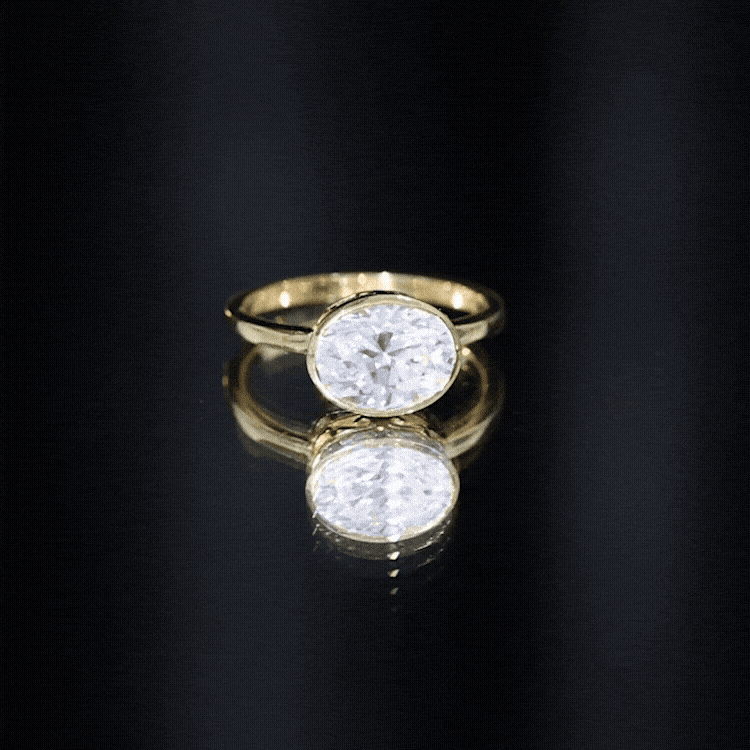 Yellow gold bezel set lab grown diamond engagement ring with east-west design by Rosec Jewels showing side view of the ring.