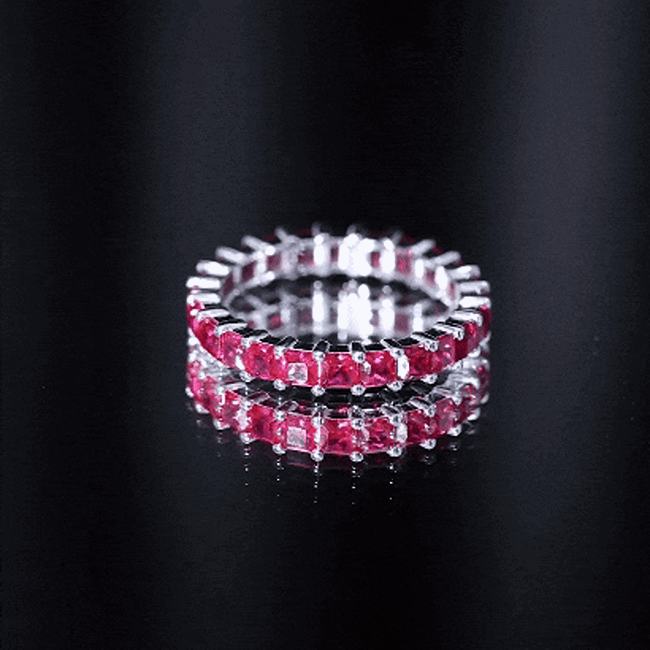 Princess cut lab-grown ruby eternity wedding ring for women by Rosec Jewels, featuring a continuous band of sparkling rubies.