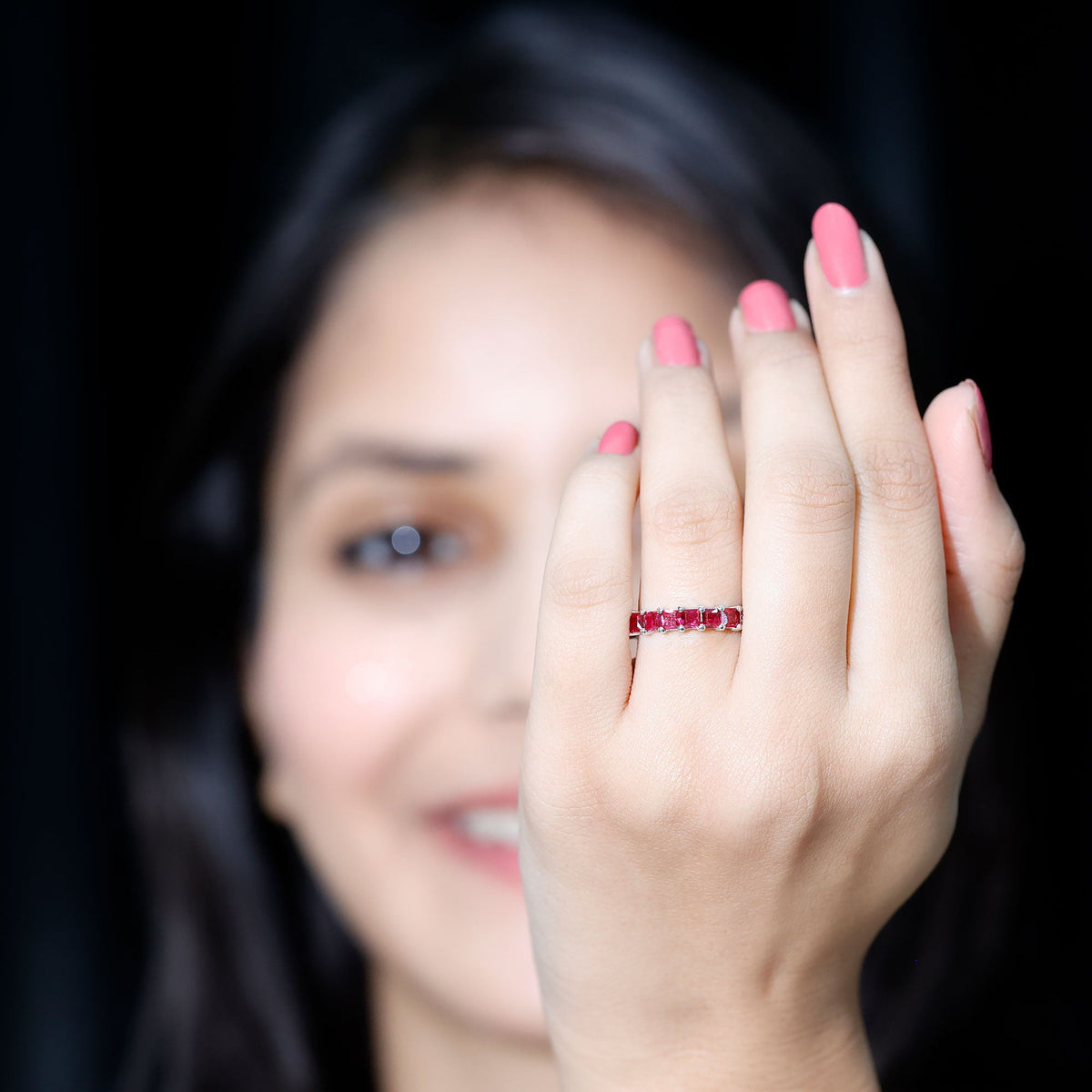 Elegant princess cut lab-grown ruby eternity wedding band for women by Rosec Jewels, showcasing sparkling red gemstones in a continuous circle.