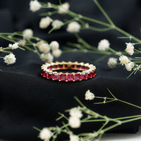 Elegant princess cut lab-grown ruby eternity wedding band for women with sparkling gemstones, crafted by Rosec Jewels.