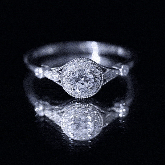 Round cut moissanite antique engagement ring with intricate band details, featuring a central sparkling stone set in a vintage-inspired design.
