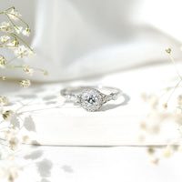 Round cut moissanite antique engagement ring featuring intricate vintage design, set in a delicate band with detailed craftsmanship.