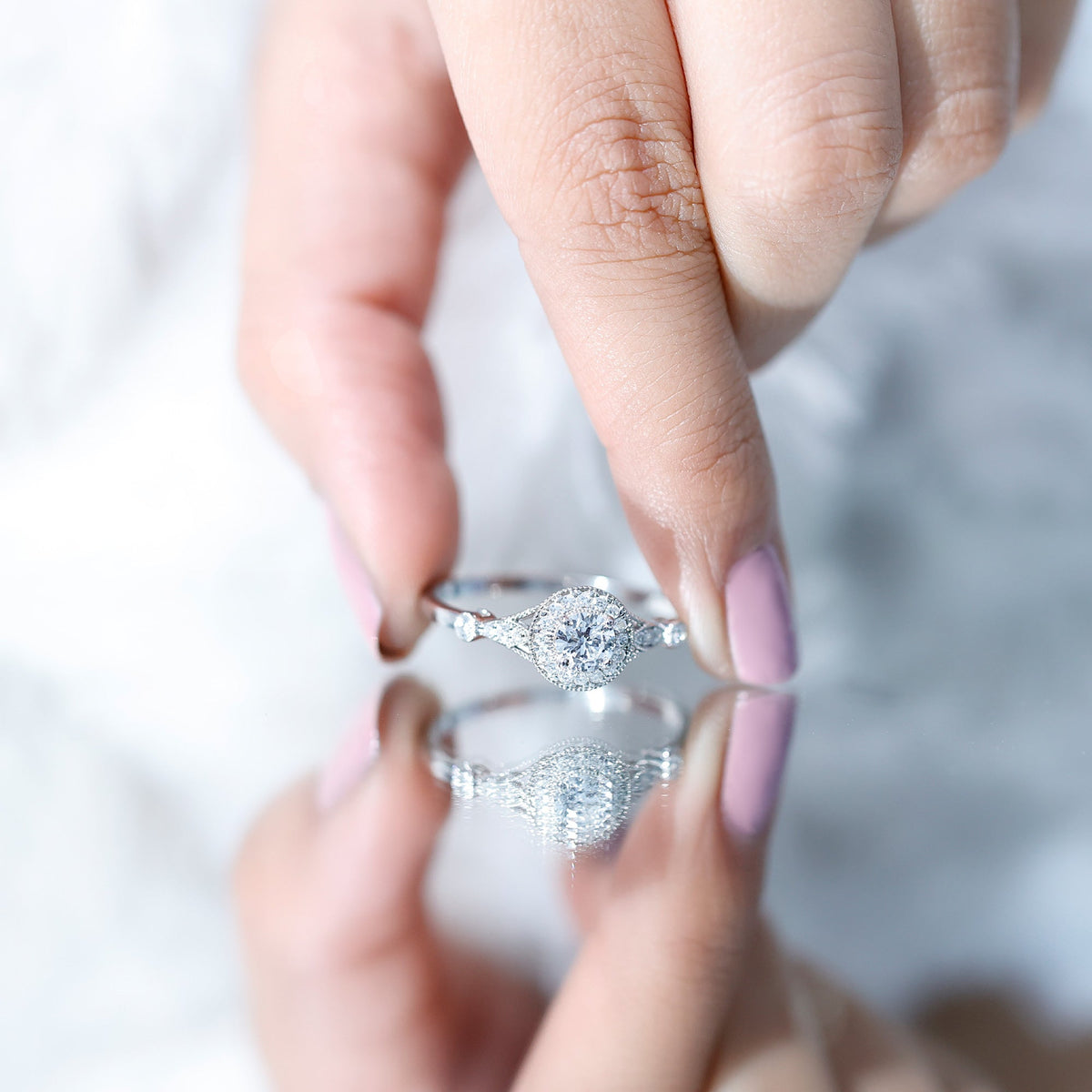 Round cut moissanite antique engagement ring featuring a vintage-inspired design with intricate metalwork and sparkling gemstone.