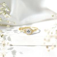 Round cut moissanite antique engagement ring from Rosec Jewels featuring intricate vintage-inspired design and a sparkling central stone.