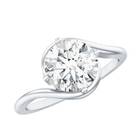 Round cut 2 carat moissanite solitaire engagement ring with bypass shank, featuring a polished gold band and sparkling center stone.