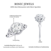Brilliant cut moissanite engagement ring with rope frame, featuring a sparkling central stone and intricate gold detailing.