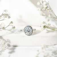 Certified Moissanite engagement ring with bezel setting and crossover shank by Rosec Jewels, showcasing sparkling center stone and sleek design.