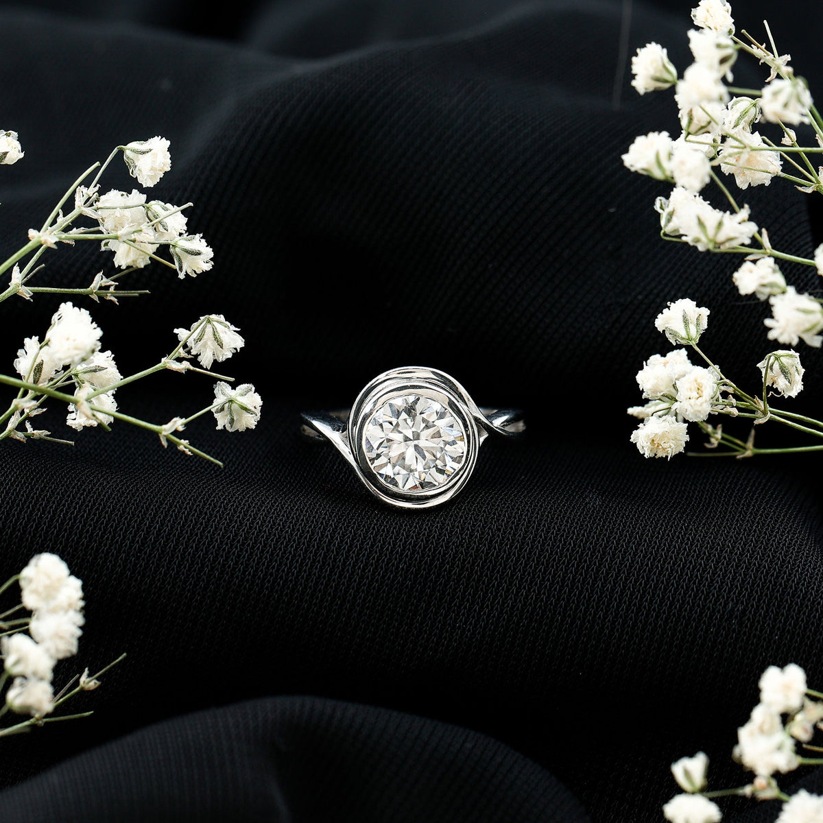 Rosec Jewels certified moissanite engagement ring with bezel setting and crossover shank, showcasing a sparkling central gemstone and elegant band.