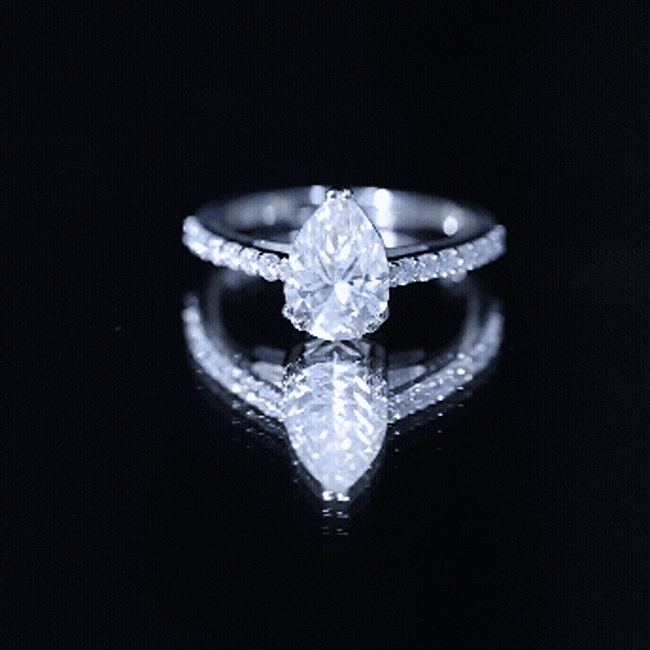 Yellow gold certified 2 carat moissanite pear-shaped engagement ring with side stones from Rosec Jewels.