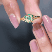 Vintage-inspired emerald flower engagement ring from Rosec Jewels featuring a detailed floral design and sparkling gemstone.