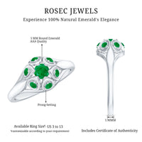 Vintage-inspired emerald flower engagement ring by Rosec Jewels featuring a detailed floral design and sparkling gemstone centerpiece.