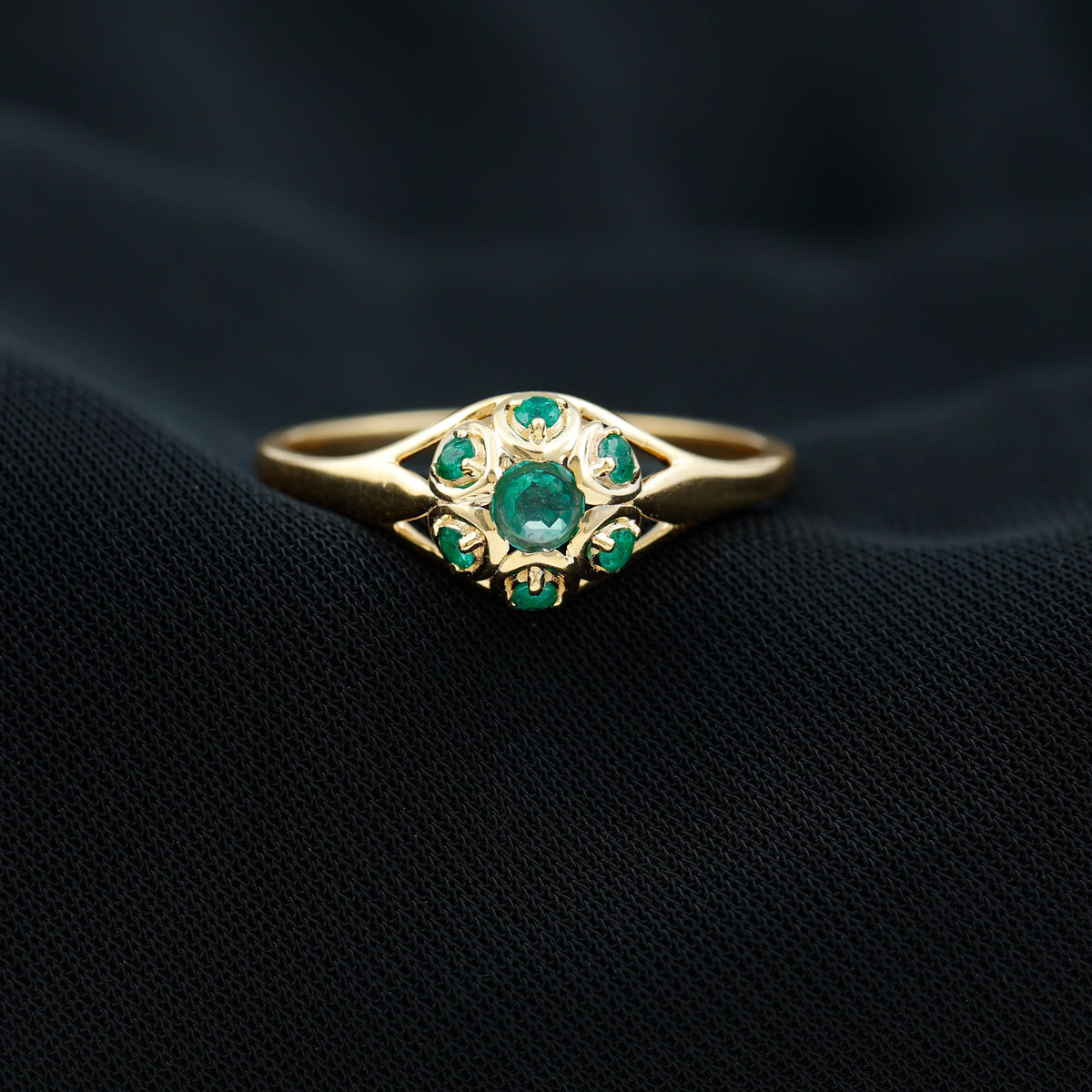 Vintage-inspired emerald flower engagement ring by Rosec Jewels featuring a central emerald gemstone with floral detailing.