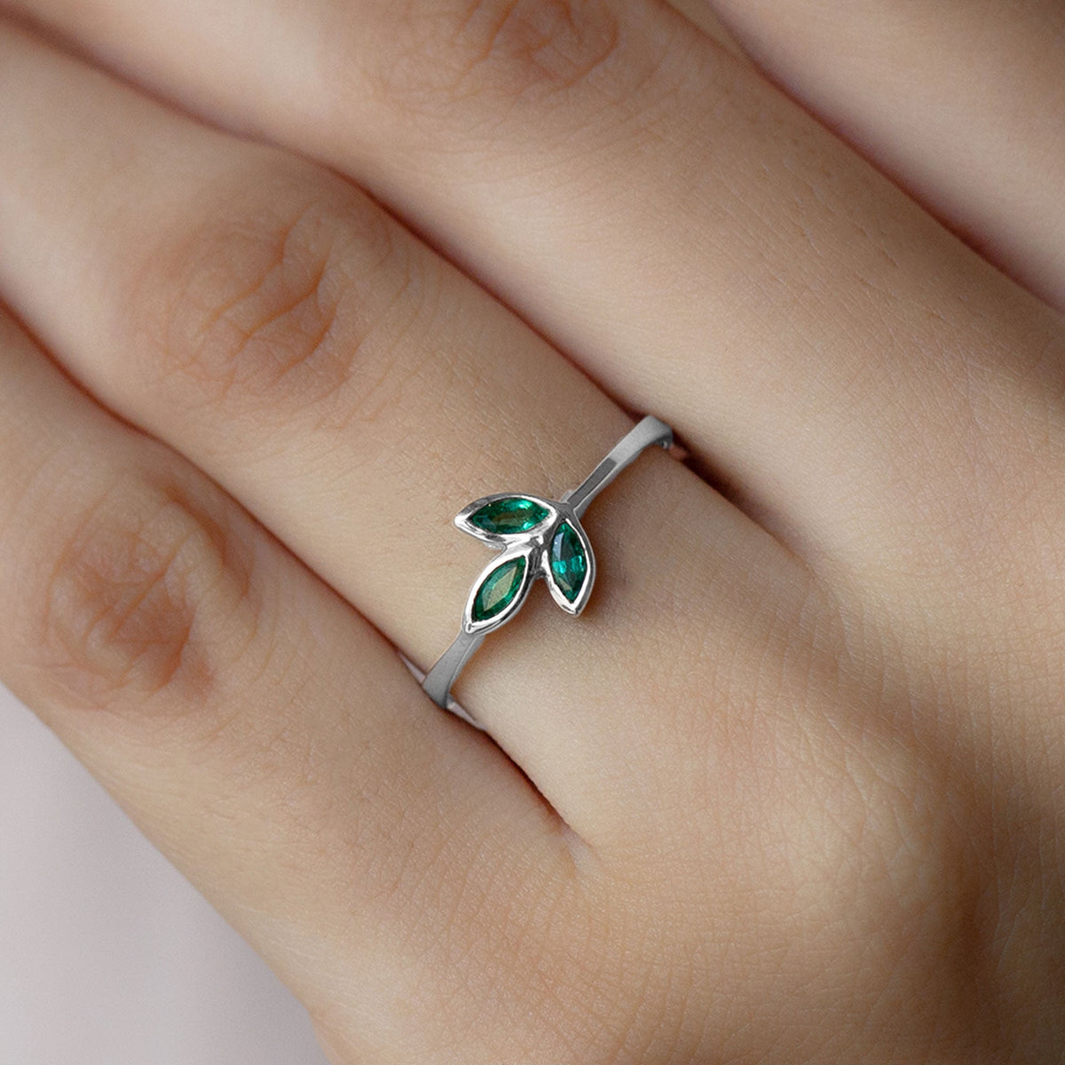 Marquise cut emerald leaf promise ring in bezel setting by Rosec Jewels, showcasing a detailed green gemstone design.