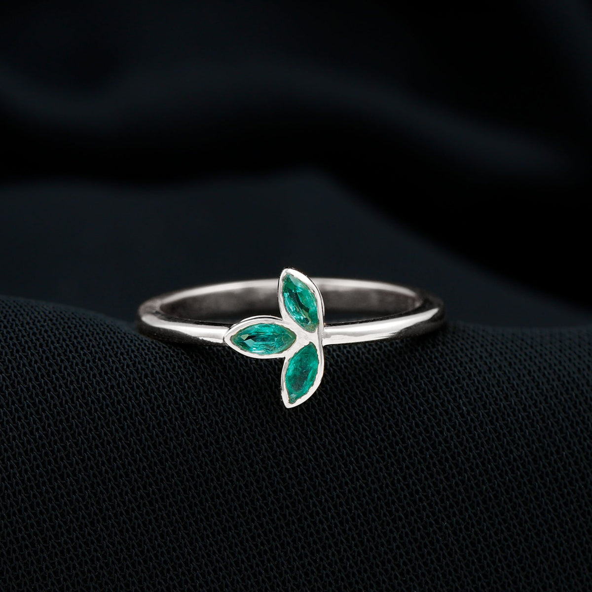 Marquise cut emerald leaf promise ring by Rosec Jewels featuring a bezel setting and intricate leaf design.