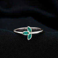 Marquise cut emerald leaf promise ring by Rosec Jewels featuring a bezel setting and intricate leaf design.