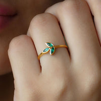 Marquise cut emerald leaf promise ring in bezel setting by Rosec Jewels, featuring detailed leaf design and sparkling green gemstone.