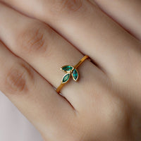 Marquise cut emerald leaf promise ring in bezel setting by Rosec Jewels, showcasing detailed leaf design and sparkling green gemstone.