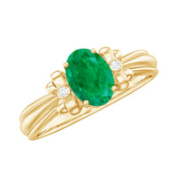 Oval cut emerald solitaire engagement ring with bow design, featuring a gold band and intricate detailing by Rosec Jewels.