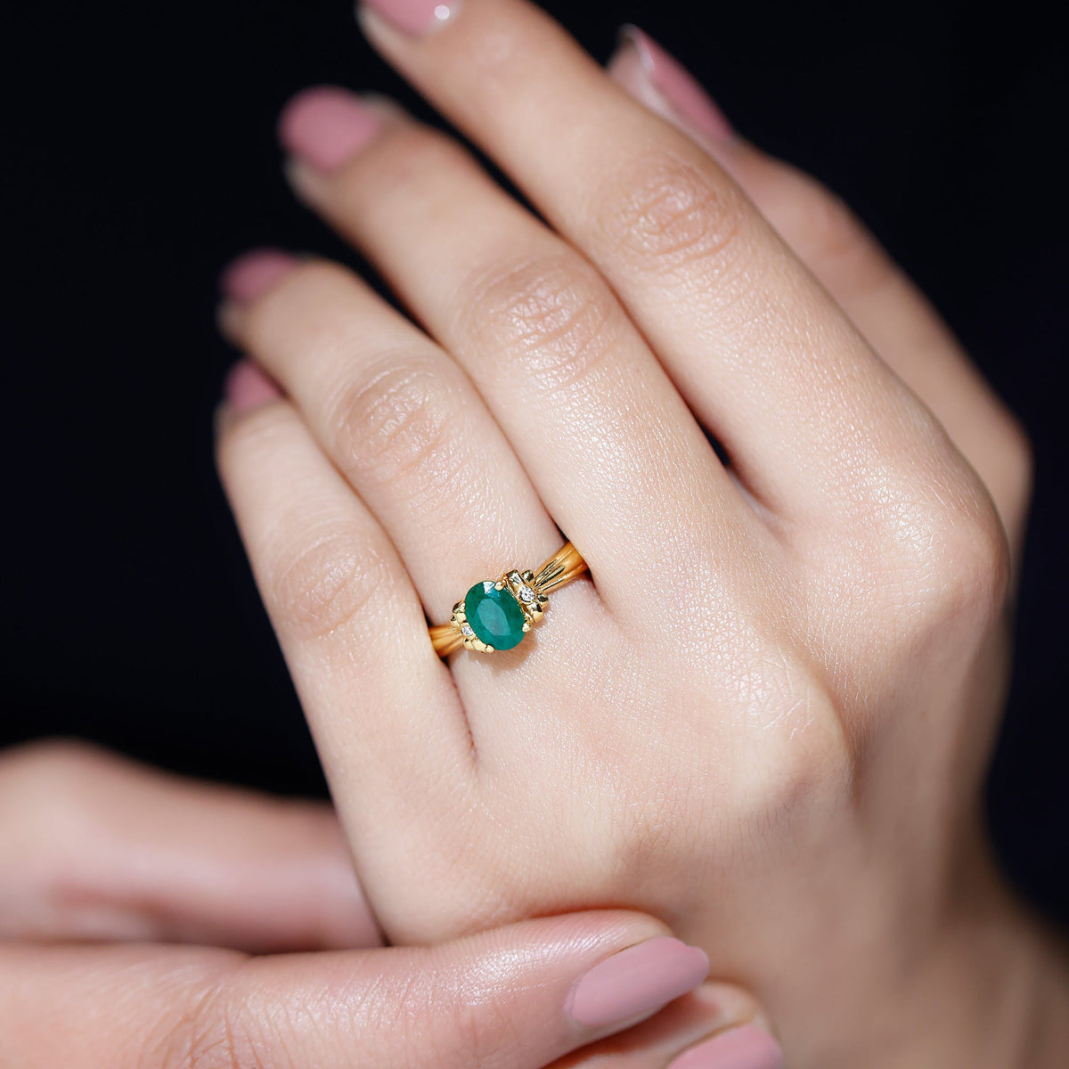 Oval cut emerald solitaire engagement ring with bow design by Rosec Jewels, showcasing a sparkling green gemstone and elegant craftsmanship.