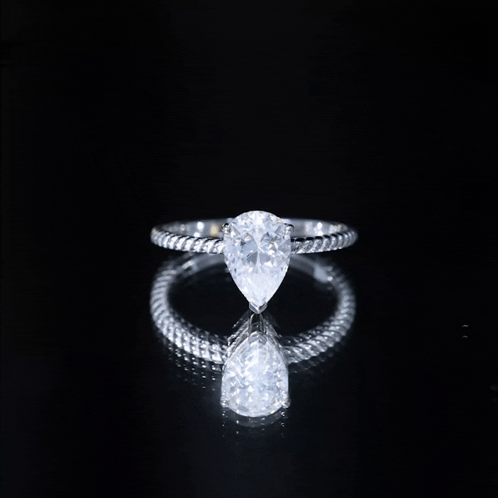 Yellow pear-shaped moissanite solitaire engagement ring by Rosec Jewels, showcasing a brilliant cut gemstone on a sleek band.