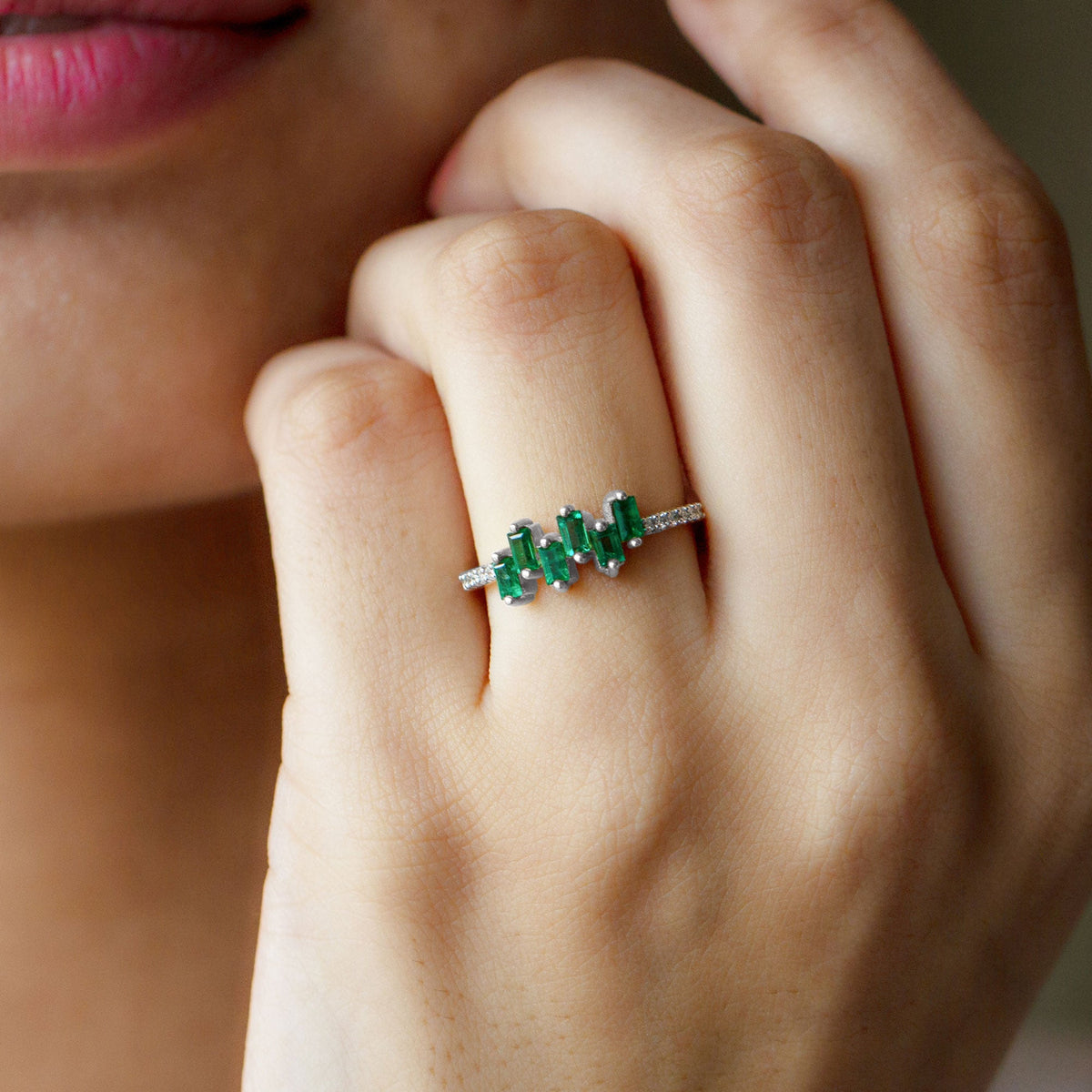 Rosec Jewels emerald promise ring with baguette cut emerald centerpiece and diamond side stones, elegant silver band.