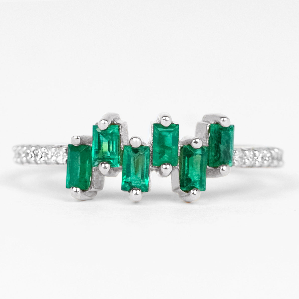 Rosec Jewels emerald promise ring featuring baguette cut emerald center stone with diamond side stones on a silver band.