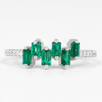 Rosec Jewels emerald promise ring featuring baguette cut emerald center stone with diamond side stones on a silver band.