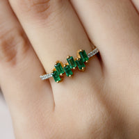 Rosec Jewels emerald promise ring with baguette cut emerald center and diamond side stones, elegant and sparkling jewelry piece.