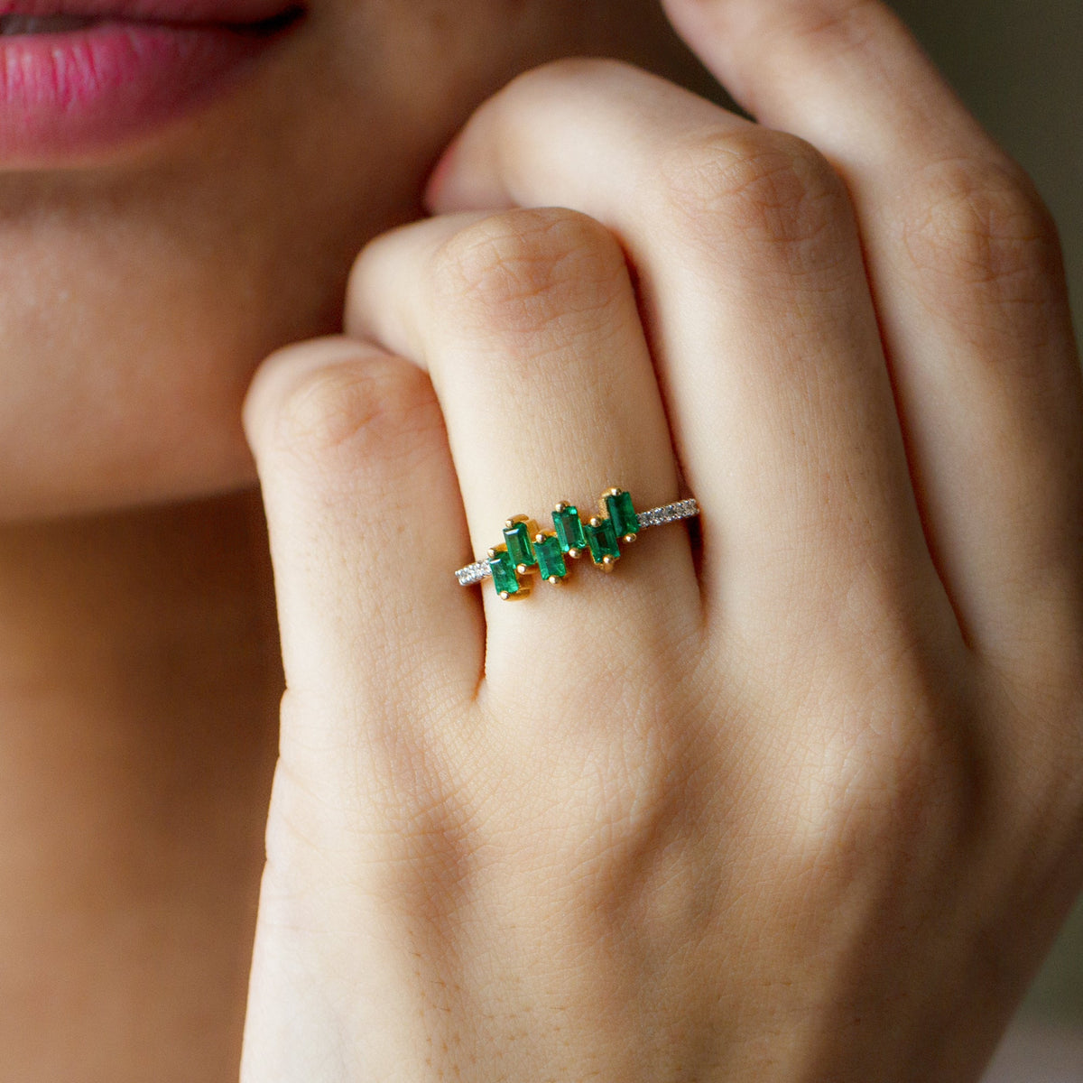 Elegant emerald promise ring with baguette cut emerald center and diamond side stones in rose gold by Rosec Jewels.