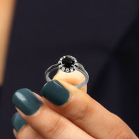 Lab-created black and white diamond halo engagement ring from Rosec Jewels featuring a 1.3 carat center stone and intricate band design.