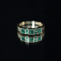 Natural emerald princess cut band ring from Rosec Jewels featuring a sleek silver band and a central emerald gemstone.