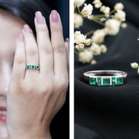 Natural emerald princess cut band ring by Rosec Jewels featuring a central emerald gemstone and a sleek, elegant gold band.