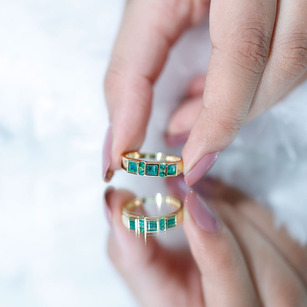 Natural emerald princess cut band ring by Rosec Jewels, showcasing a sparkling green gemstone set in a sleek silver band.