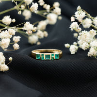 Natural emerald princess cut band ring by Rosec Jewels featuring a central emerald gemstone set in a sleek ring design.