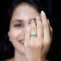 Pear-shaped emerald anniversary wedding ring with diamond accents from Rosec Jewels, featuring a polished gold band and intricate design.
