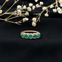 Pear-shaped emerald anniversary wedding ring by Rosec Jewels with diamond accents, featuring a sparkling emerald gemstone and elegant design.