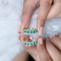 Pear-shaped emerald wedding ring with diamond accents by Rosec Jewels, featuring a elegant design and sparkling gemstones.