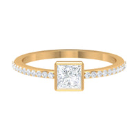 Rosec Jewels 3/4 CT bezel set cubic zirconia solitaire ring with side stones, showcasing a shiny silver band and sparkling gemstones.